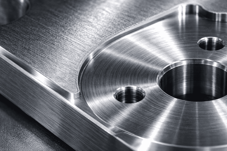 Photorealistic close-up of a machined metal surface showing varying texture and roughness under industrial lighting